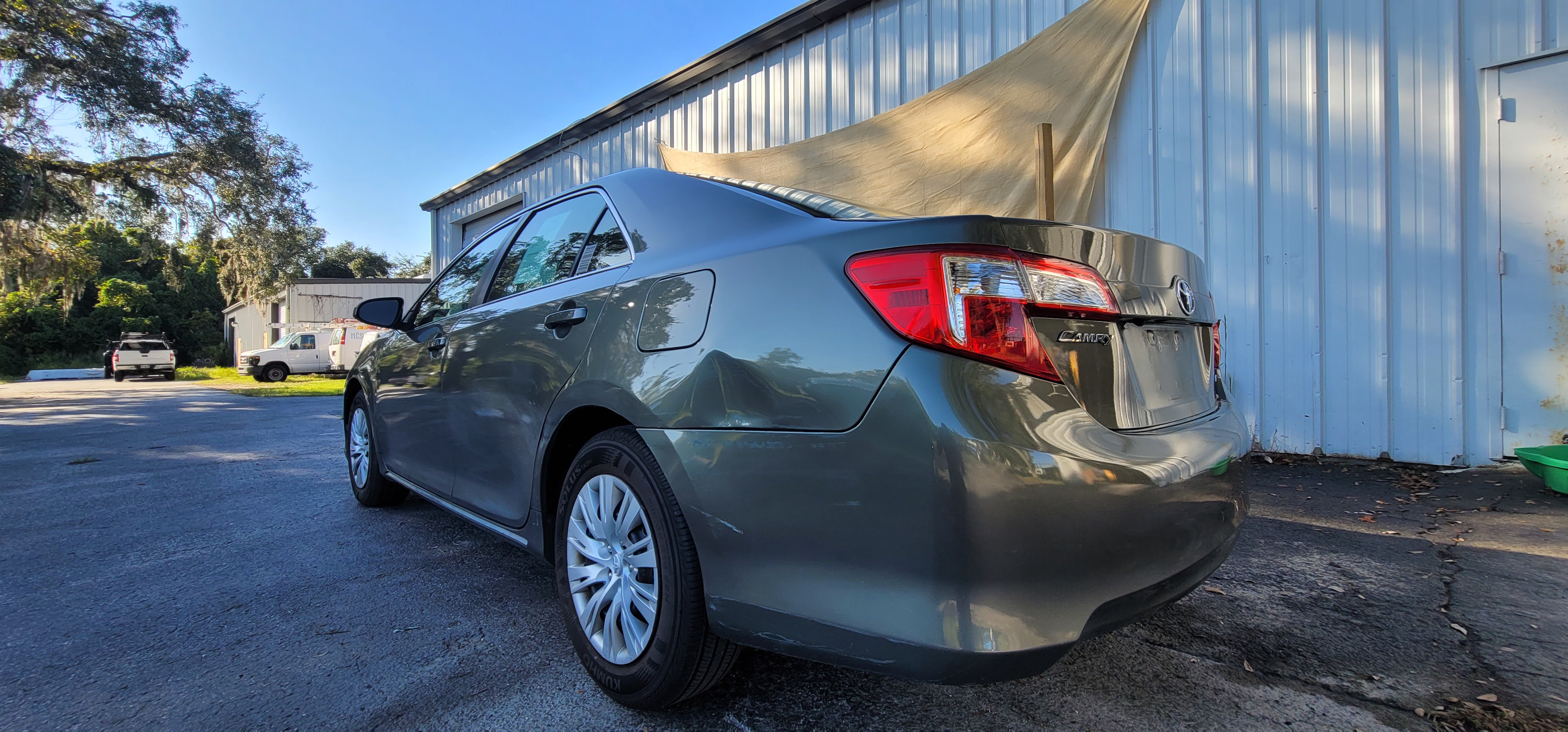 Toyota Camry LE completed full respray - rear quarter showing deep gloss and perfect color match at The Drip