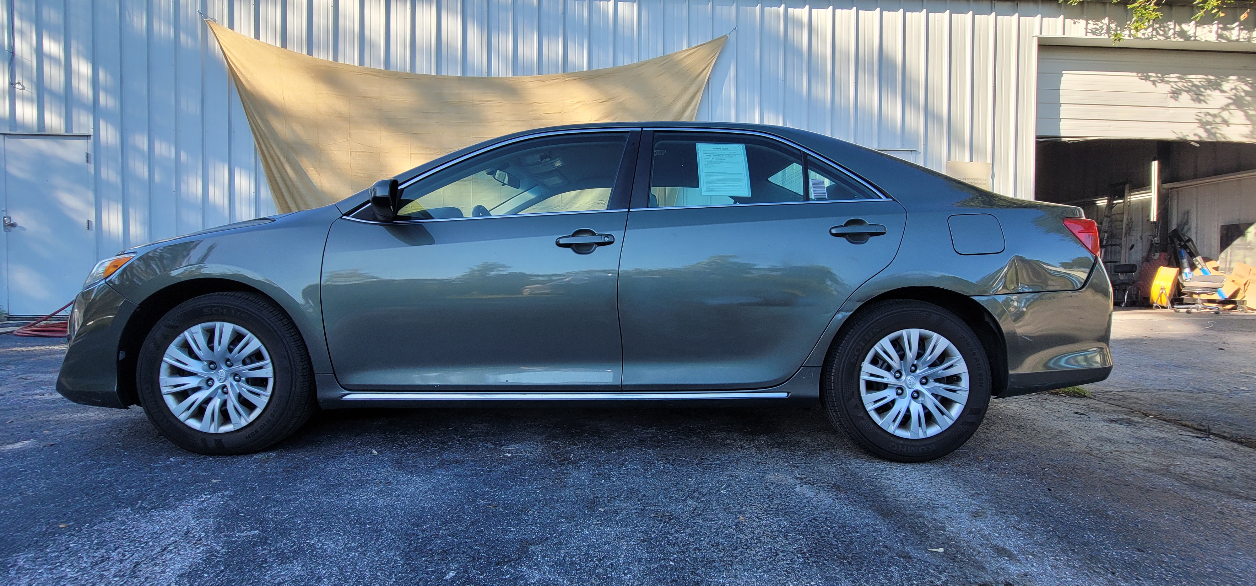 Toyota Camry LE after full respray - flawless side profile showing mirror finish at The Drip Leesburg FL