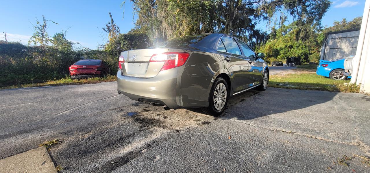 Toyota Camry rear view after paint restoration showing glossy finish at The Drip Auto Body