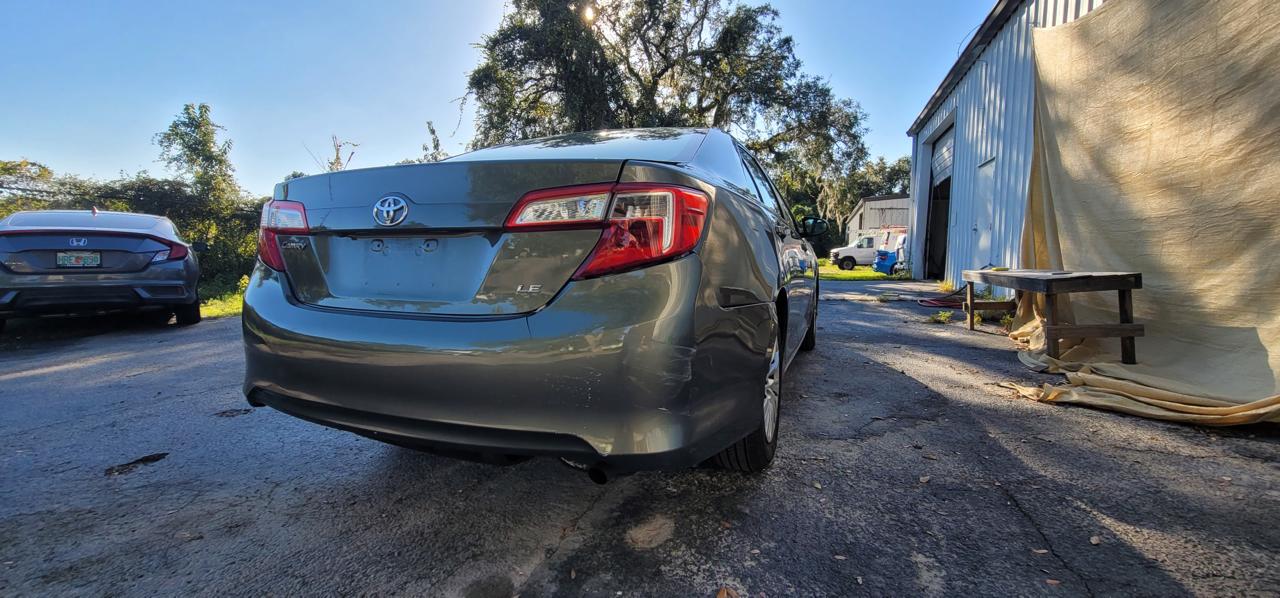 Toyota Camry LE rear low angle after complete paint restoration at The Drip Auto Body Leesburg FL