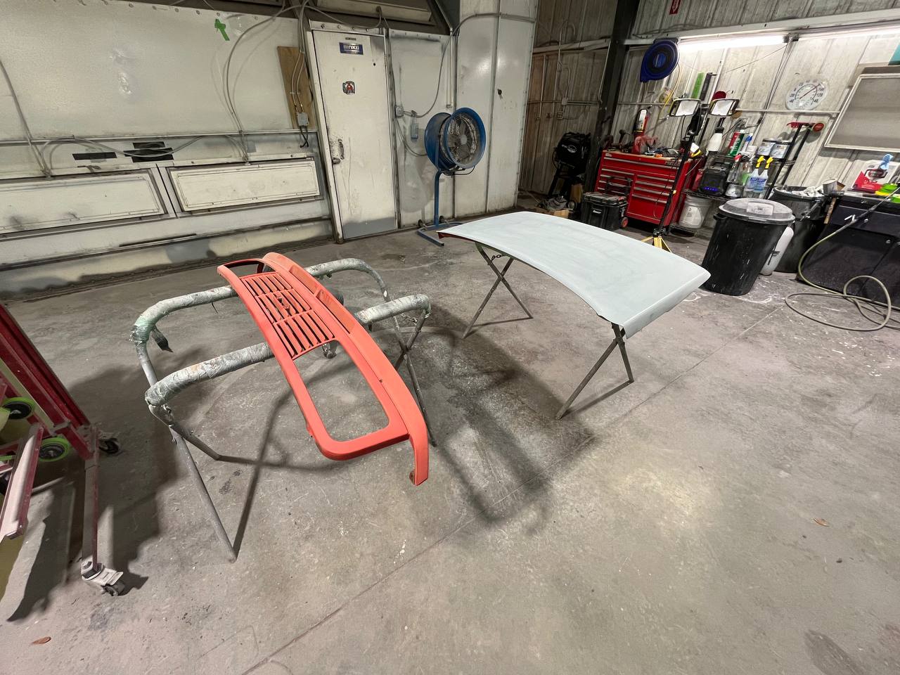 Jeep Wrangler roof panel in primer and grille frame in red primer during frame-off restoration at The Drip Leesburg FL