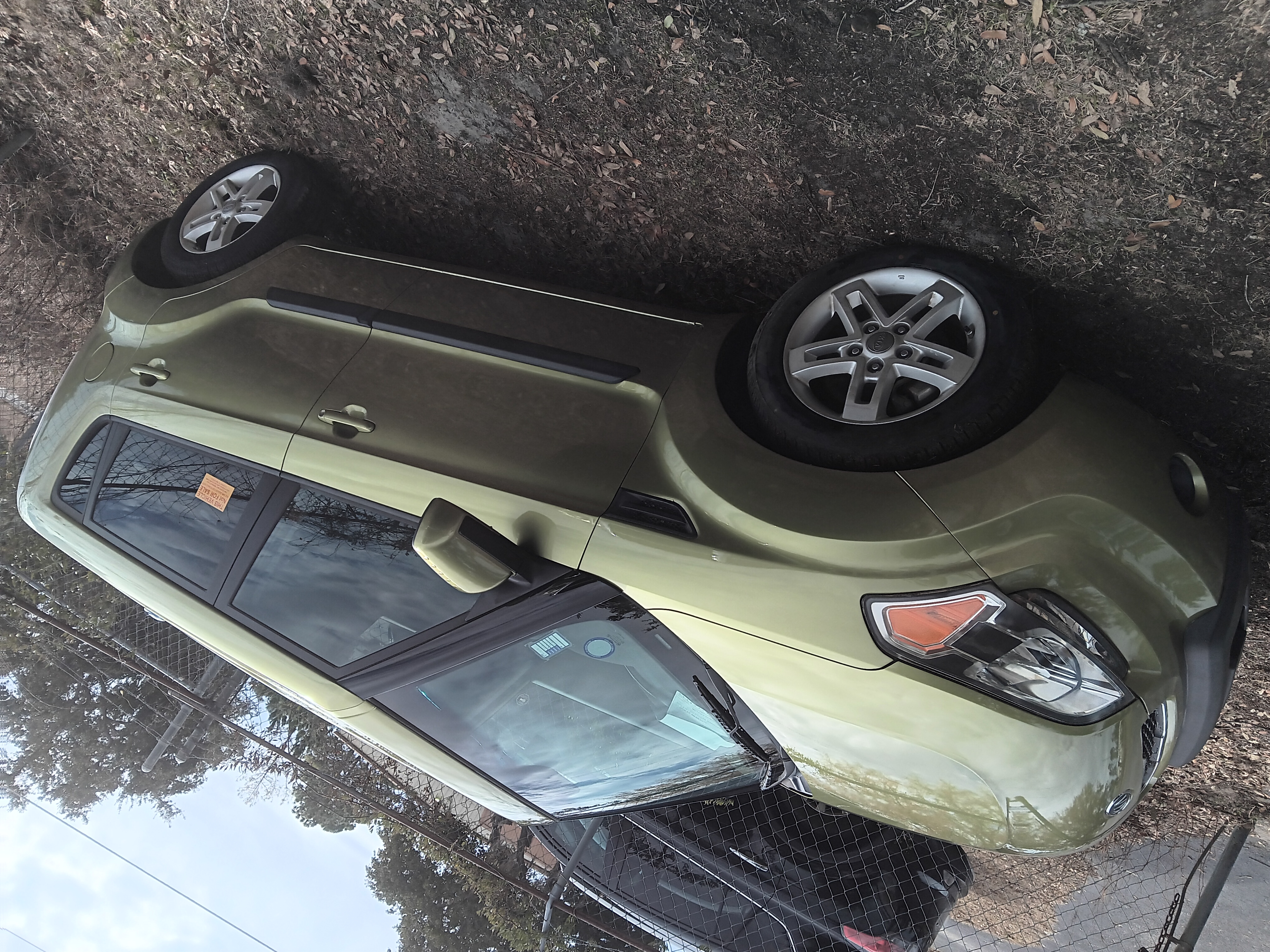 Kia Soul completed paint job - side view showing olive green finish at The Drip Auto Body Leesburg FL