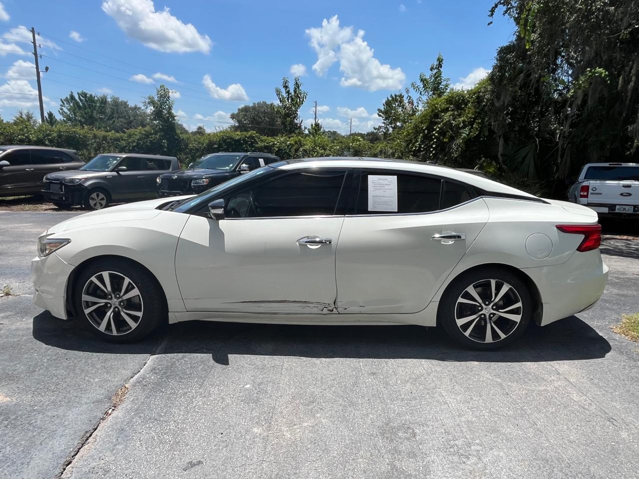 Nissan Maxima Platinum before collision repair - side scrape and rocker panel damage at The Drip Auto Body Leesburg FL