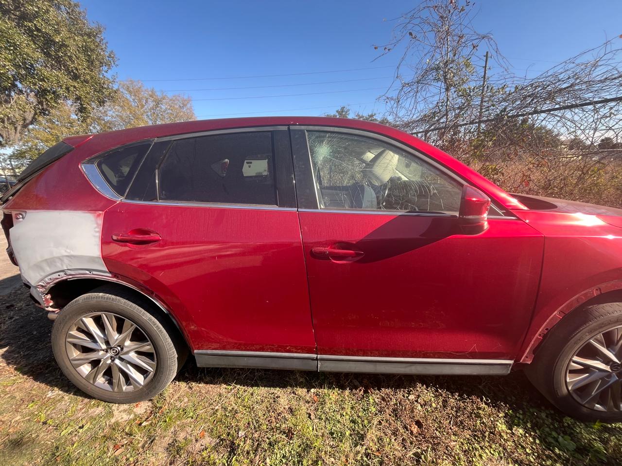 Red Mazda CX-5 rear quarter panel collision repair - replacement panel being fitted at The Drip Auto Body Leesburg FL