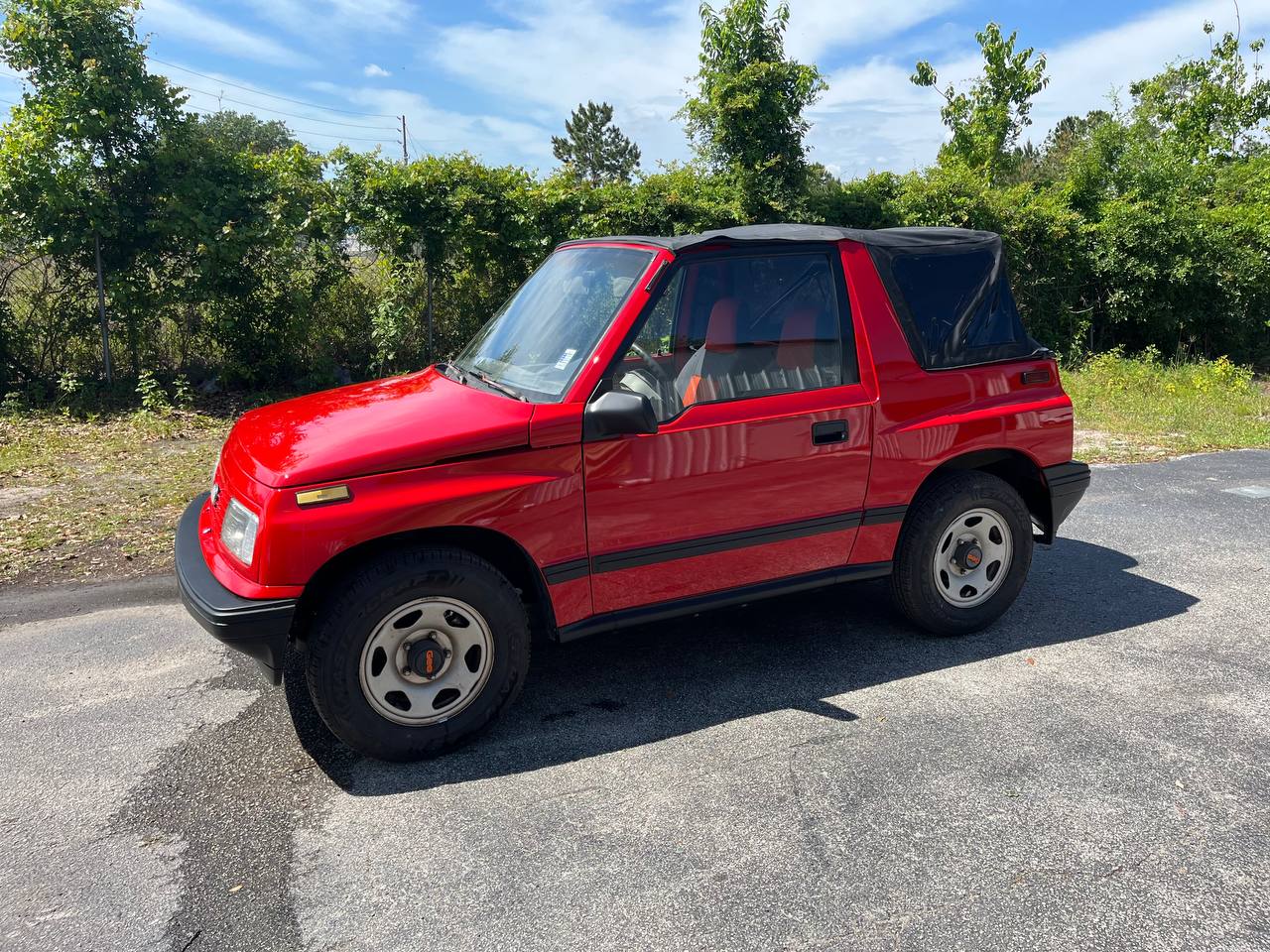 Geo Tracker soft-top full side profile after complete red paint restoration at The Drip Leesburg FL