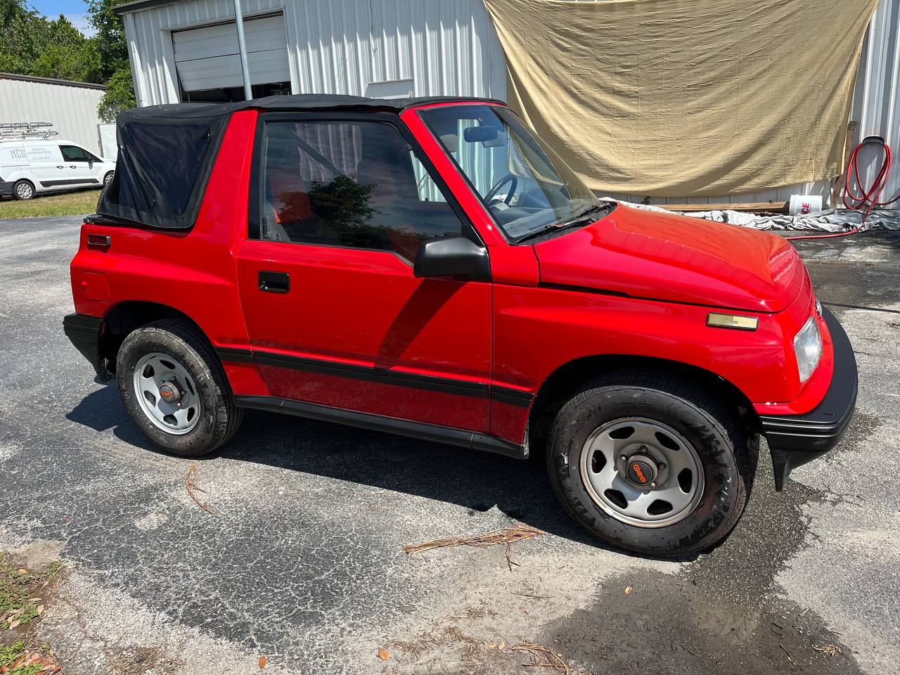 Geo Tracker red paint restoration passenger side view at The Drip Leesburg