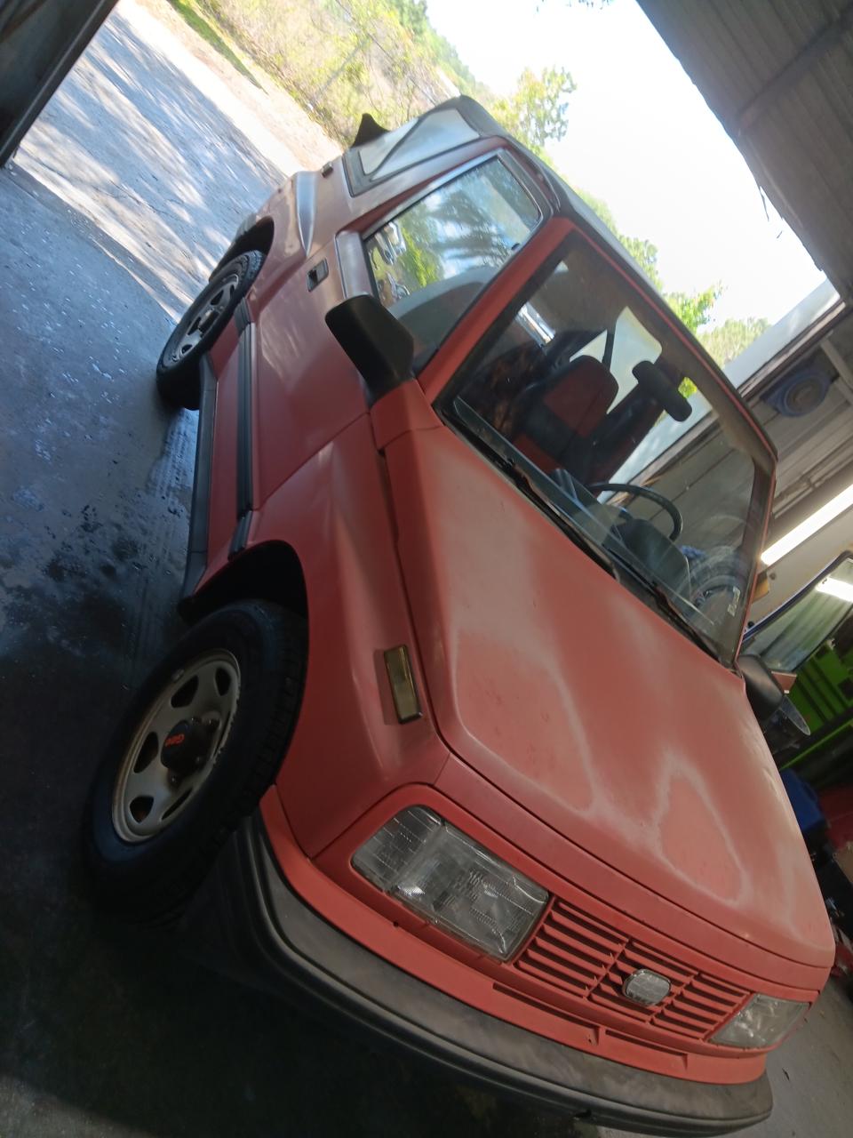 Geo Tracker restored paint - angle view showing fresh red paint at The Drip Leesburg