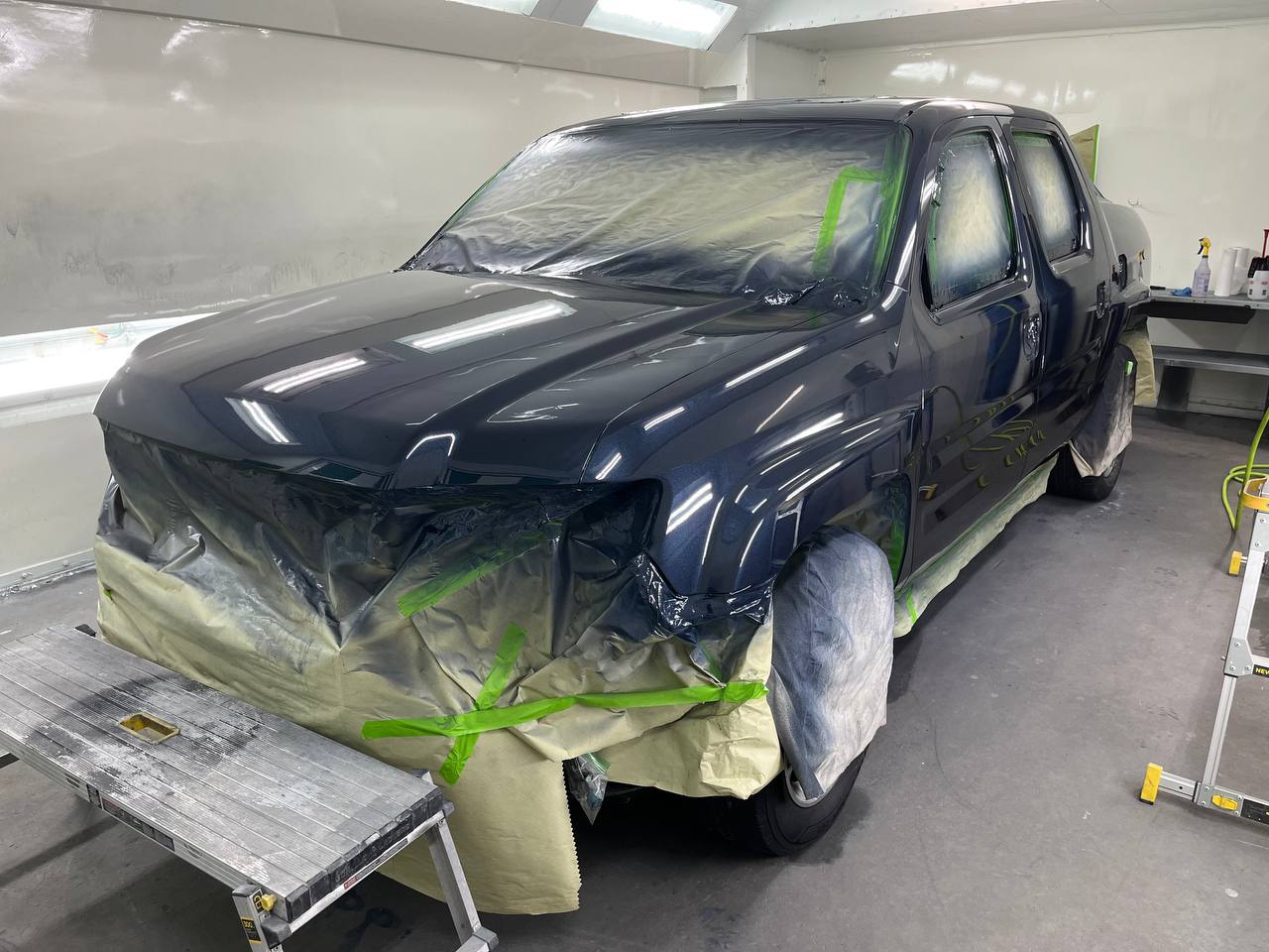 Honda Ridgeline in paint booth - masked and sprayed
